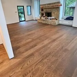 Hardwood floor around a living room fireplace