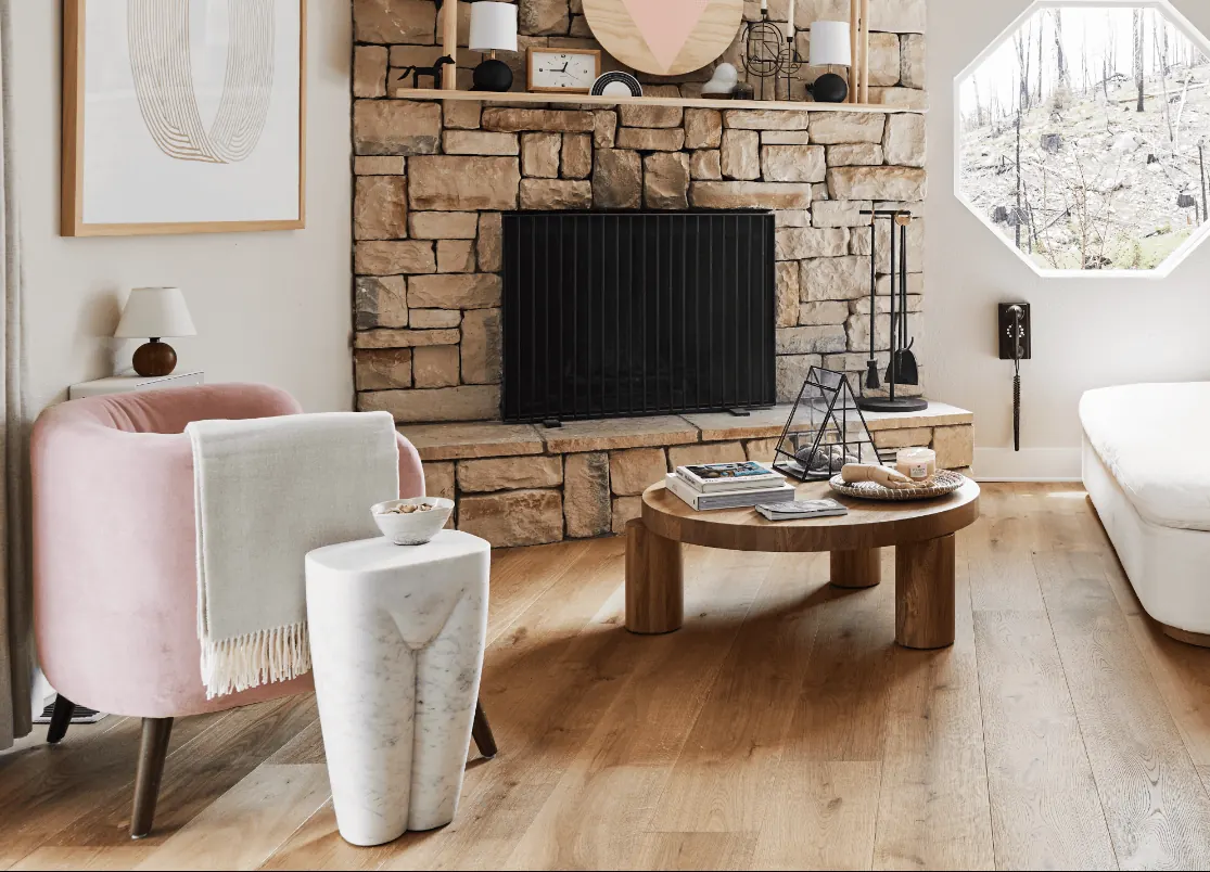 Warm oak floor beside a stone fireplace